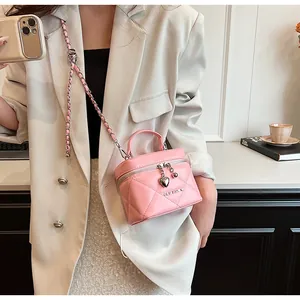 Detailansicht der rosa gesteppten Mini-Handtasche mit Herz-Reißverschluss und Kettenriemen