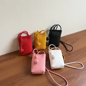 Mini crossbody phone bags in five vibrant colors with textured leather and knot charms