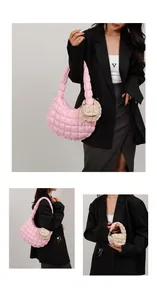 Detail of pink quilted cloud bag with beige mini charm pouch on fluffy shoulder strap
