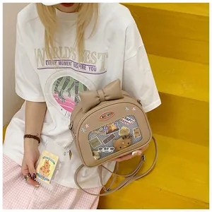 Detail of JK style bag featuring a large bow and transparent window for accessories
