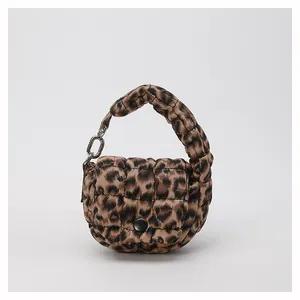 Detail view of leopard print quilted mini cloud bag with silver metal ring and button