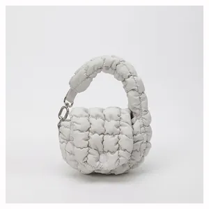 Macro detail of off-white quilted cloud bag featuring soft texture and silver hardware