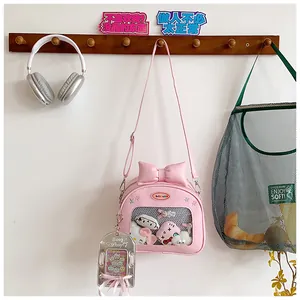 Pink heart-shaped ita bag featuring a large bow and transparent window for plush display