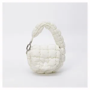 Detailed close-up of white quilted mini cloud bag with soft fabric and silver metal links