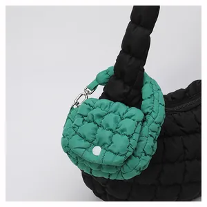 Detail view of the quilted texture and puff design of the cloud bag with mini charm