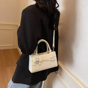 Minimalist cream white bow handbag with adjustable crossbody strap and silver buckle