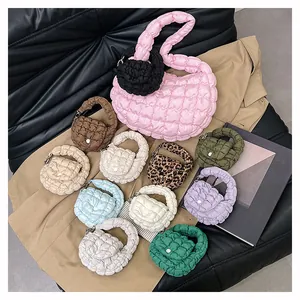 Detailed arrangement of mini quilted cloud bags in various colors on a stylish background