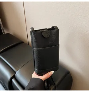 Detail view of black lychee grain soft leather phone bag with magnetic flap closure