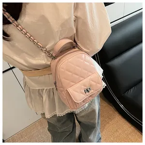 Dettaglio di uno zainetto trapuntato rosa con spallacci a catena argento su una modella