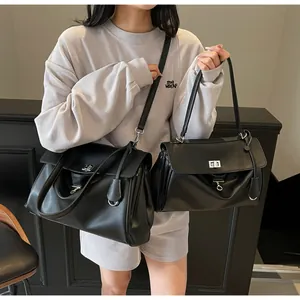 Size comparison between large and small black leather minimalist shoulder bags with silver locks