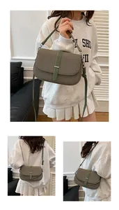 Detailed views of an olive green textured shoulder bag with silver metallic buckle