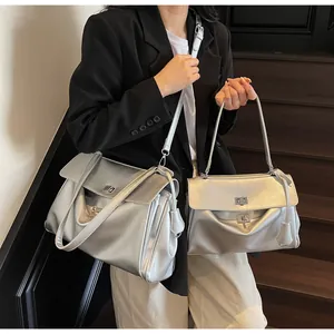 Detailed comparison of large and small silver Boston shoulder bags with metallic finish