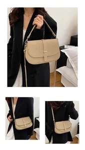 Detail of beige woven crossbody bag with silver hardware and adjustable leather straps