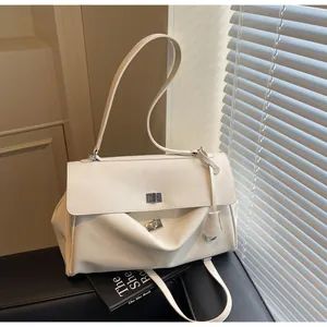 Close-up of white PU leather bag featuring double silver metal twist locks and a soft texture