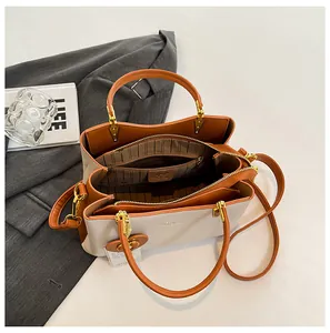 Three-compartment beige and brown leather handbag with striped lining and logo detail