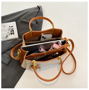 Top view of multi-compartment interior for handbag showing storage space for essentials