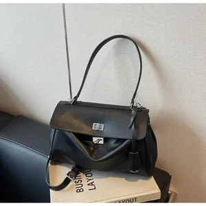 Detail of black leather shoulder bag with silver turn-lock clasp and double strap design