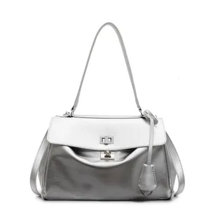 Minimalist silver underarm bag for women featuring a metallic finish and twist lock closure