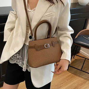 Brown textured women's tote bag with silver buckle and crossbody strap for daily commute