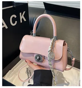 Pink faux leather square handbag with scarf and tennis racket charm detail
