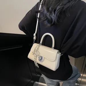 Chic cream small square crossbody bag with vintage metal lock and woven pendant for women