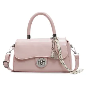 Pink crossbody square bag with badminton racket charm and silver clasp closure