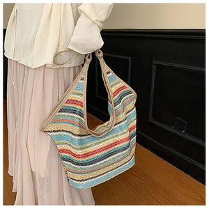 Close-up of a colorful striped woven straw tote bag with premium leather shoulder straps