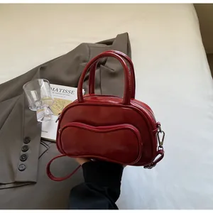 Macro detail of a vintage red glossy bowling bag on a bed with a Matisse art book