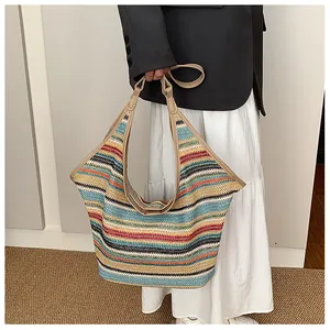 Detail showing the colorful woven texture and durable faux leather handles of the tote bag