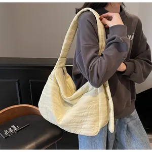 Close-up of quilted light yellow tote bag with wave stitching and soft texture details