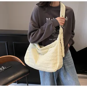 Model showcasing a pale yellow quilted large tote bag with soft wavy texture and wide strap