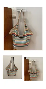Detail of colorful striped woven tote bag featuring long brown leather shoulder straps