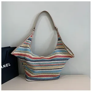 Detail of colorful striped woven hobo bag with high-quality knit texture and leather strap
