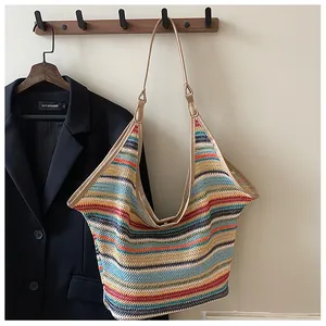 Macro detail of multi-color striped woven texture and brown leather strap on tote bag