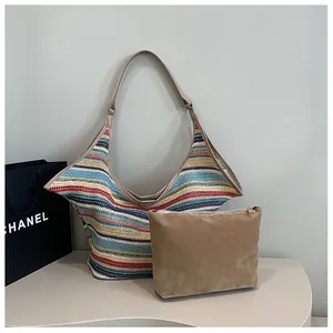 Detail of colorful striped woven tote bag with brown suede inner pouch and leather straps