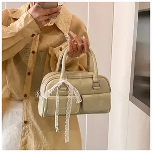 Detail view of green vintage bowling bag featuring white lace bows and double pockets