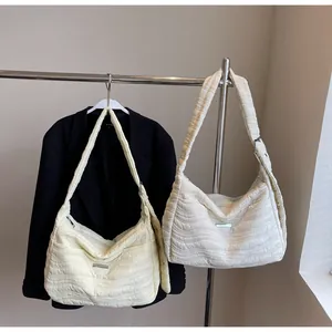 Detail of quilted wave texture on lightweight beige and white oversized tote bags