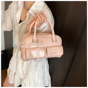 Detail of pink vintage faux leather bowling bag with front pockets and white lace bow