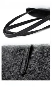 Gros plan d'un sac cabas noir avec poignées confortables et détails de couture précise