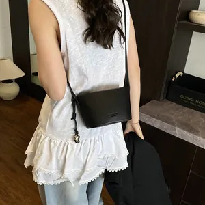 Sac seau femme noir en cuir grainé avec bandoulière et pendentif cœur en argent