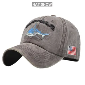 Detailed close-up of blue shark embroidery on a washed vintage cotton baseball cap