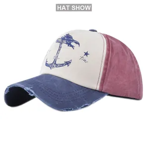 Detailed view of vintage distressed baseball cap with anchor print and tricolor canvas