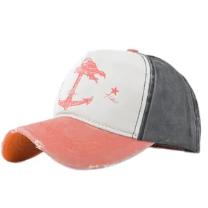 Detailed close-up of distressed brim and anchor print on a vintage baseball cap