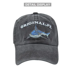 Detailed embroidery of a shark and logo on a vintage washed grey cotton baseball cap