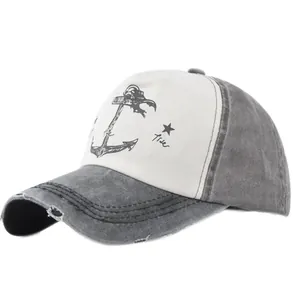 Detail of vintage anchor print on a two-tone baseball cap with distressed brim and stars