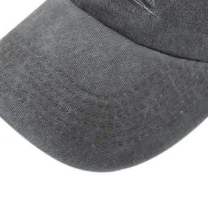 Detailed macro view of washed dark grey cotton fabric with six-row stitching on baseball cap