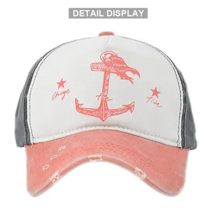 Detailed view of the distressed brim and anchor print on a vintage baseball cap
