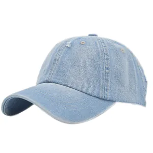 Detail of vintage washed denim baseball cap featuring distressed ripped holes and curved brim