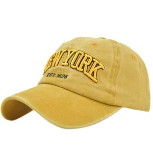 Detailed close-up of retro mustard yellow baseball cap with 3D New York embroidery