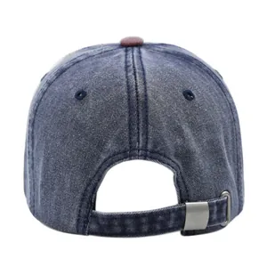 Detail of adjustable metal buckle and washed denim texture on vintage baseball cap